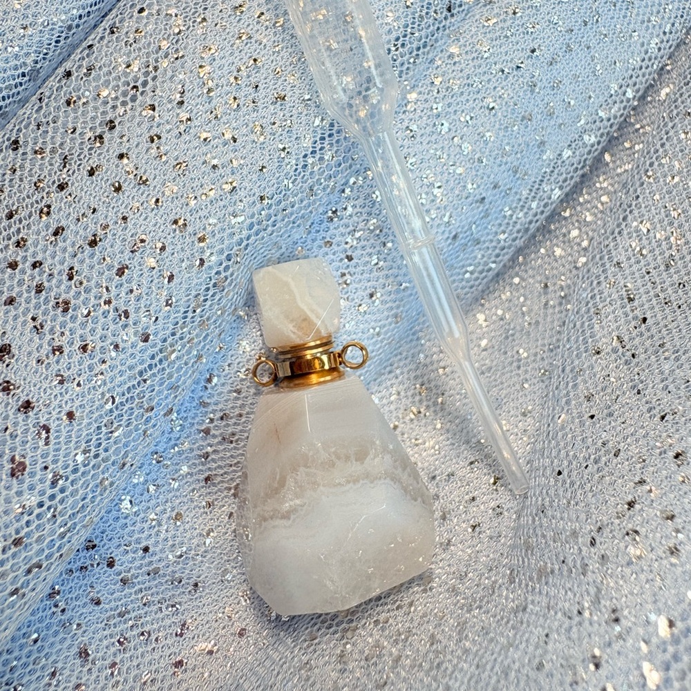 Elegant White Crystal Bottle with Gold Accents